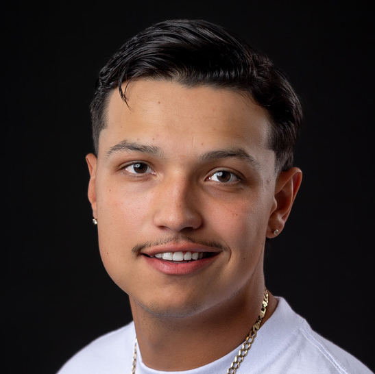 Gage Carbajal, barber at Lax Haircare in Fargo, working in the modern barbershop